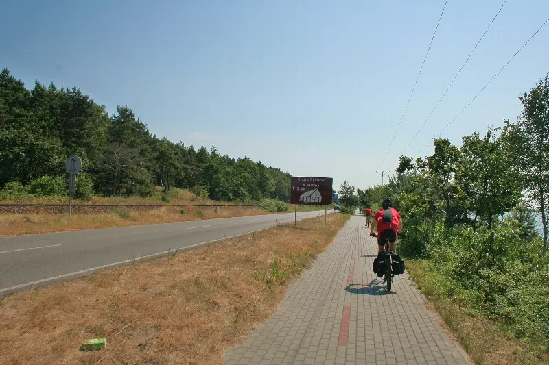 Rowerzysta na ścieżce rowerowej z kostki wzdłuż drogi wojewódzkiej 216 w Chałupach